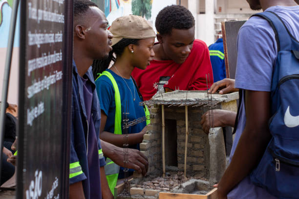Maputo, Mozambique - April 28, 2023: Young trainee engineers present mockups at a public street fair to demonstrate their acquired construction skills